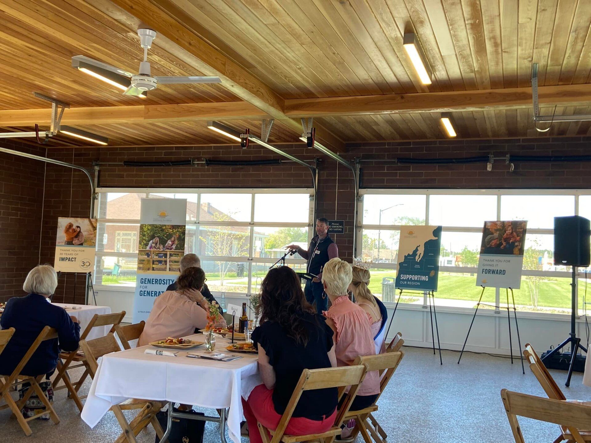 A group of people are sitting at tables in a room.