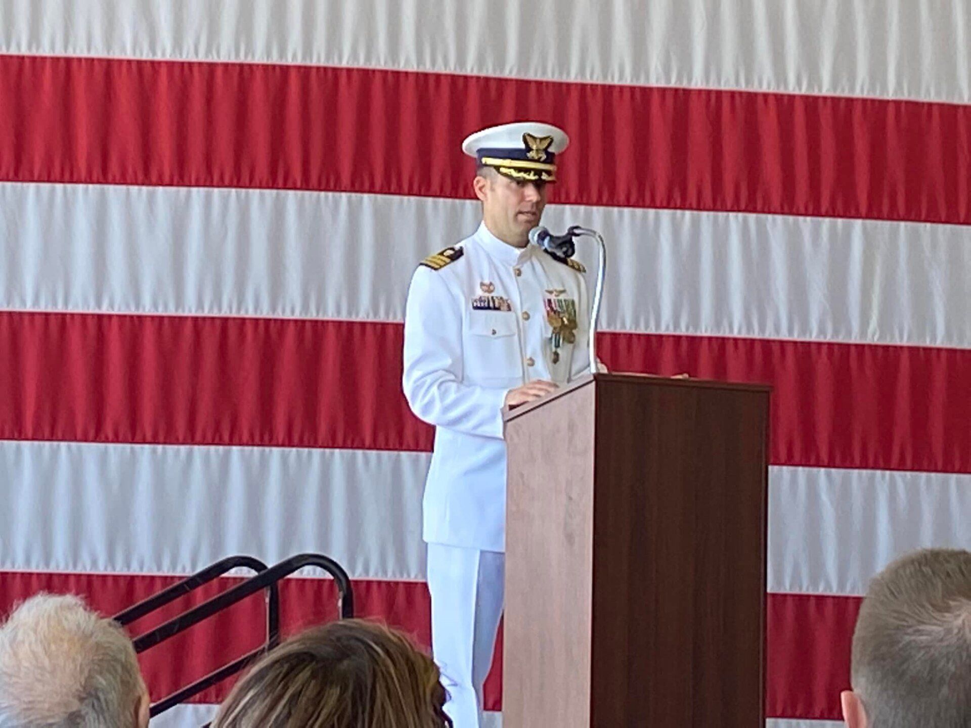 A man in a military uniform is standing at a podium giving a speech.