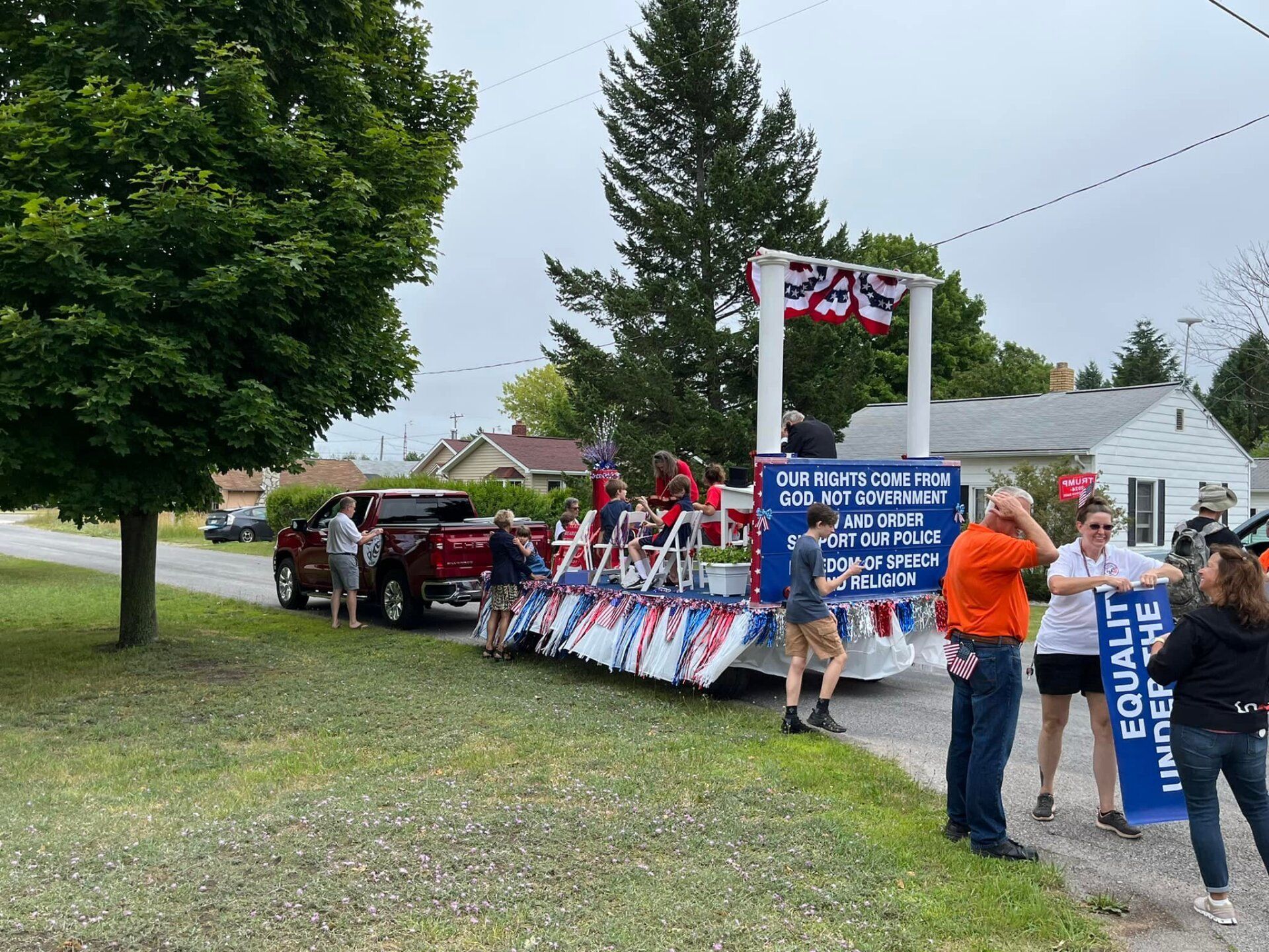 A group of people are standing in front of a float in a parade.