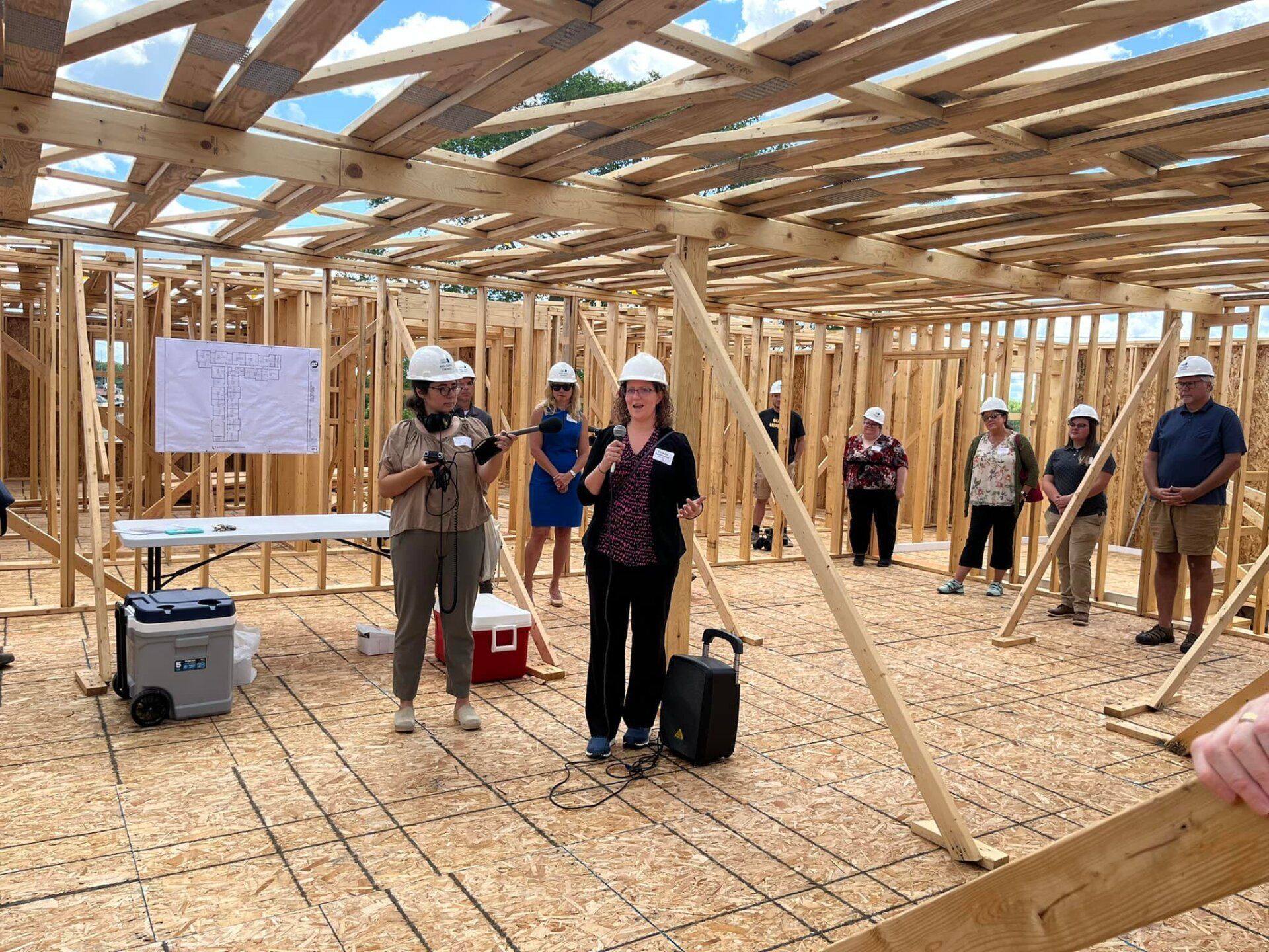 A group of people are standing in a building under construction.