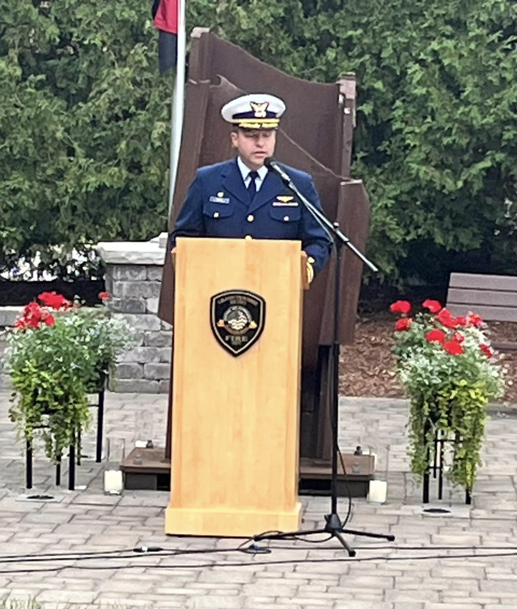 A man in a military uniform is standing at a podium giving a speech.