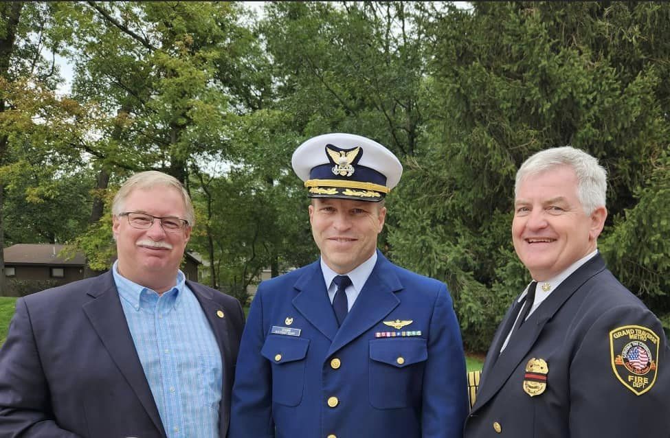 John Roth Three men in suits and military uniforms are posing for a picture.
