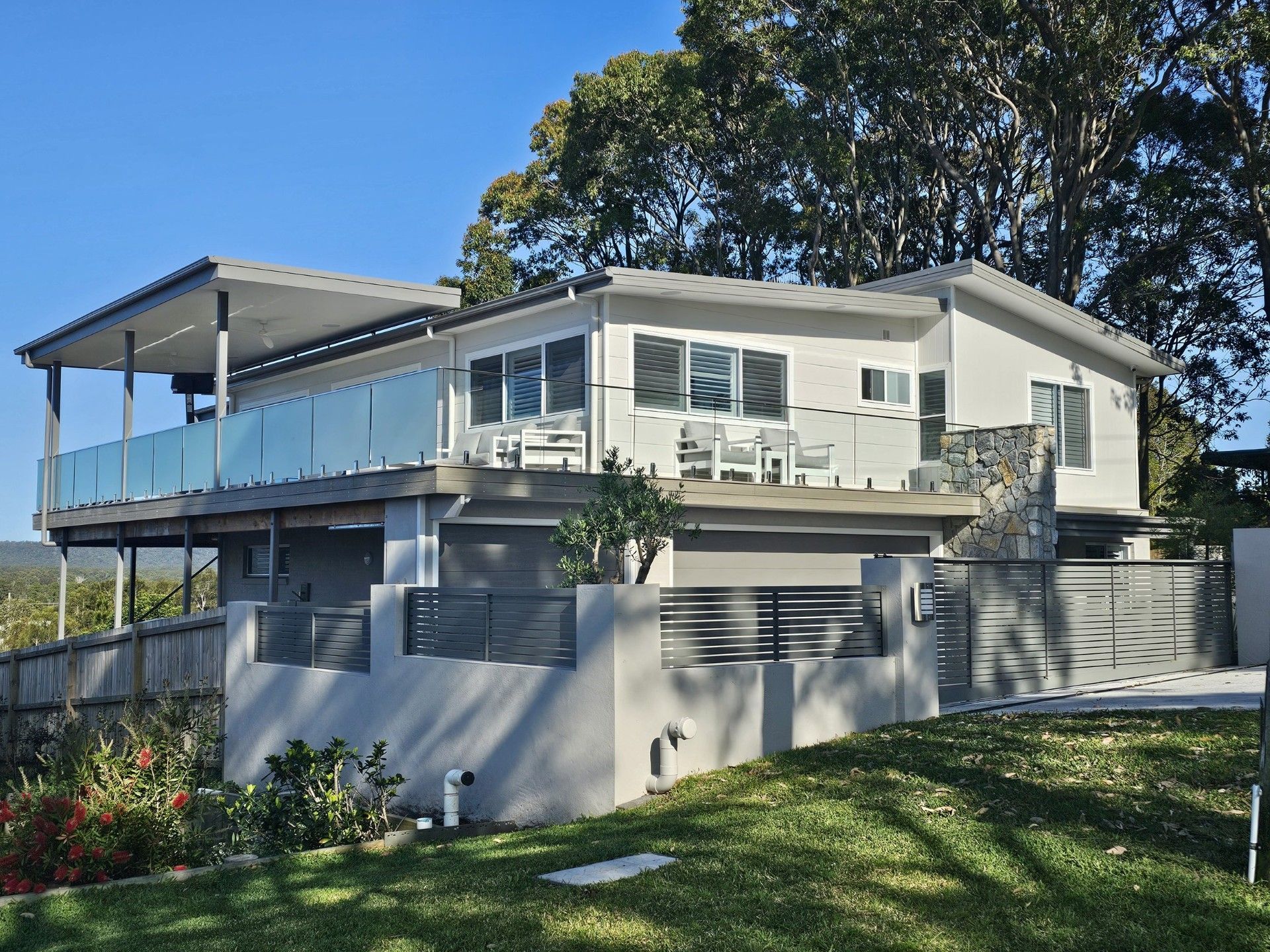 Building construction site with a partially built brick structure, scaffolding, and a scenic background.