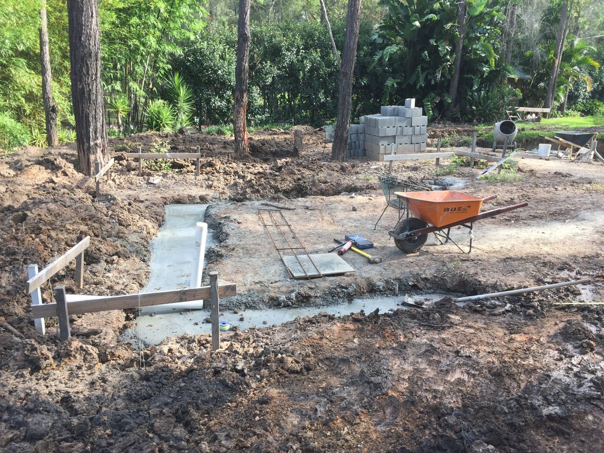 Construction site with concrete foundation and building materials.