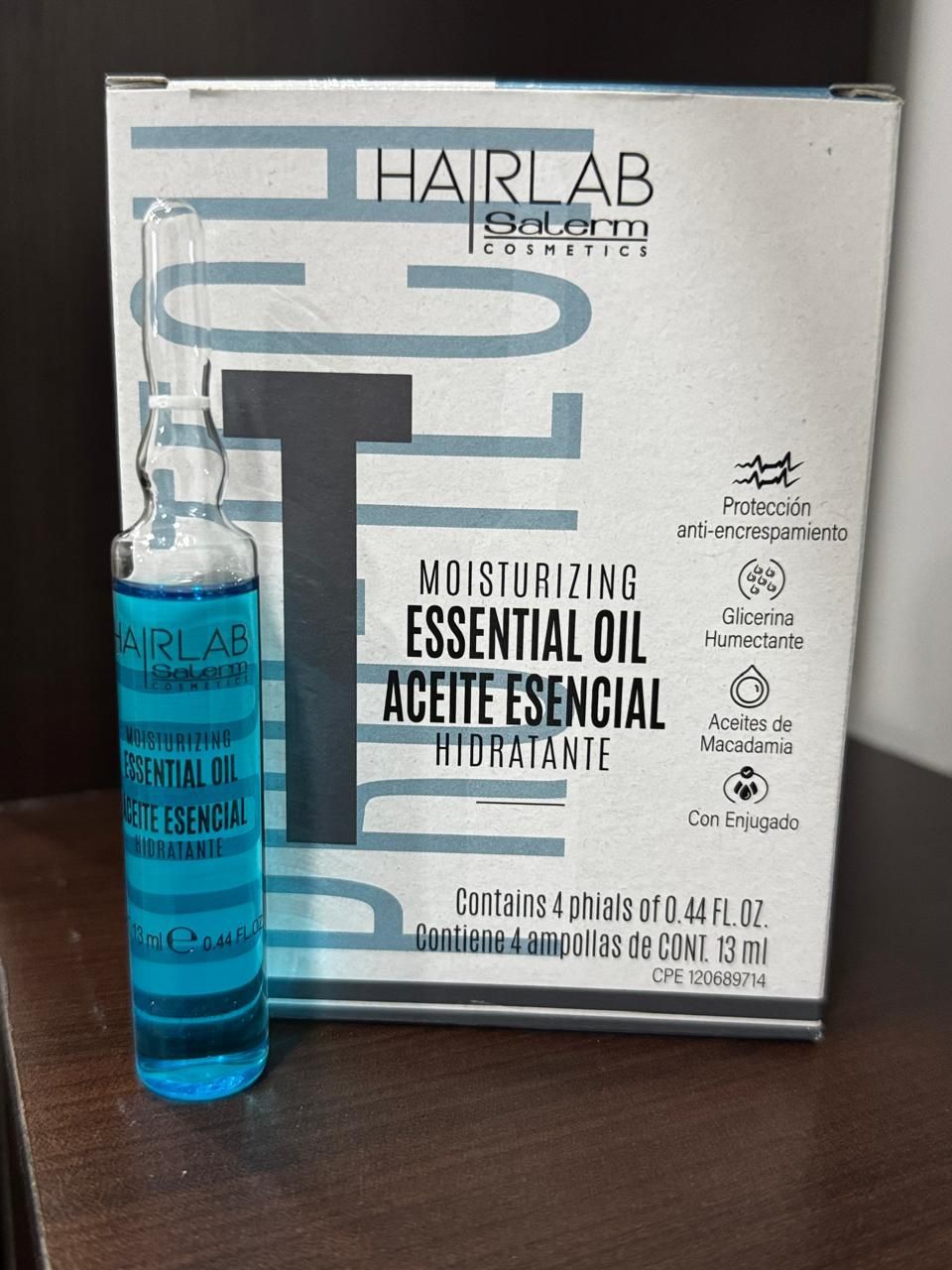 Una caja de aceite esencial de Hair Lab sobre una mesa.