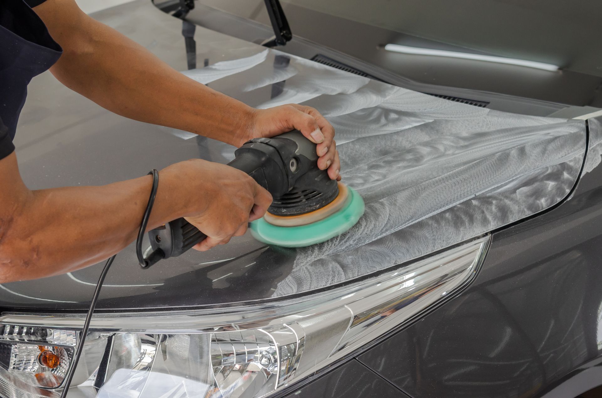 This photo shows a car waxing service applied to the exterior of a car.