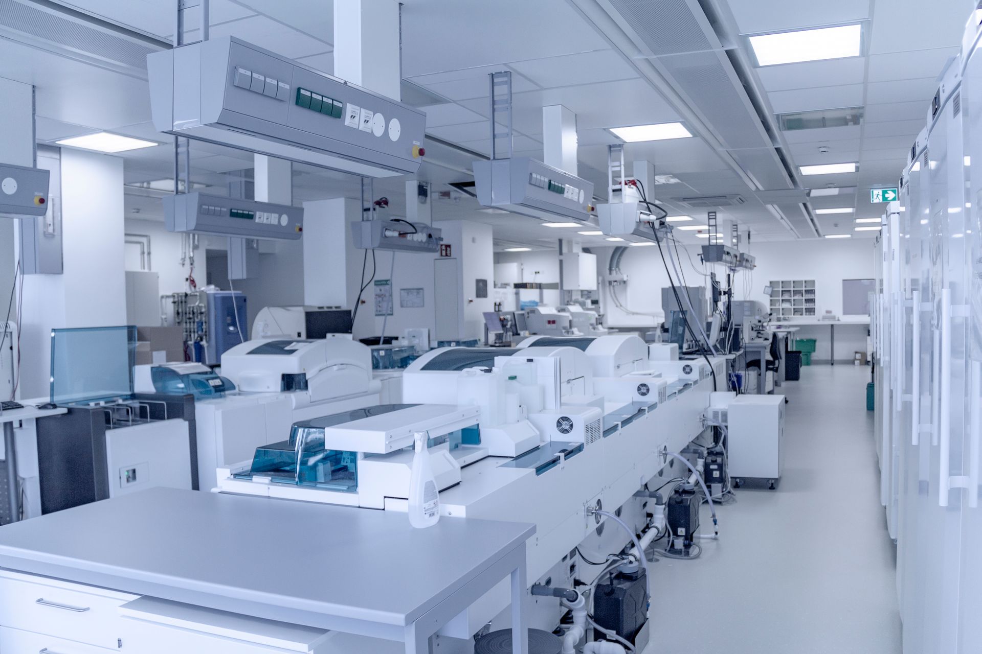 Bright industrial lab with white automated machines and equipment in a clean manufacturing facility