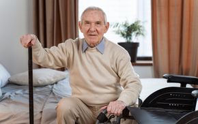 senior man sitting with cane