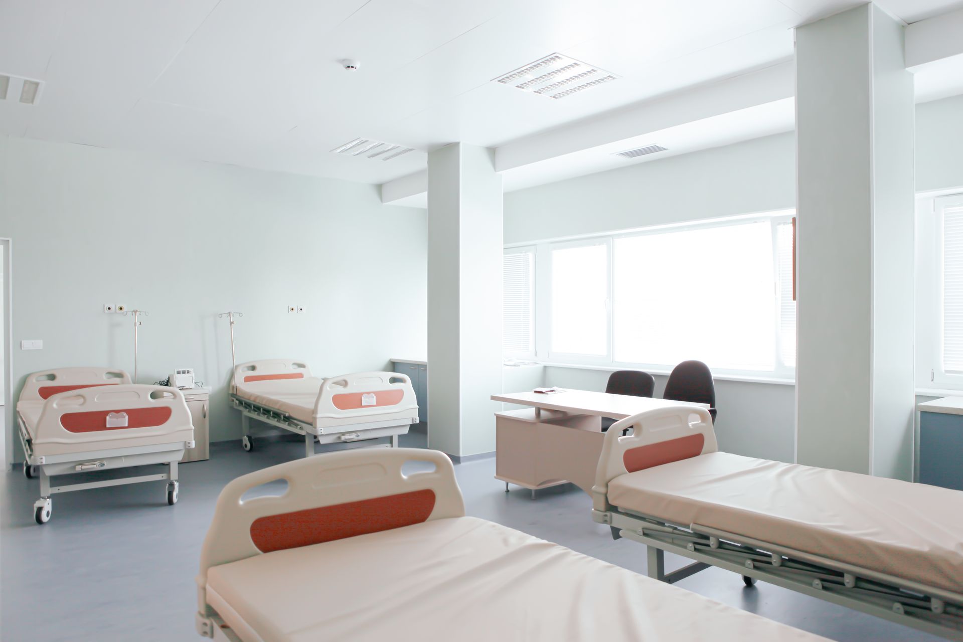 There are a lot of hospital beds in this room.