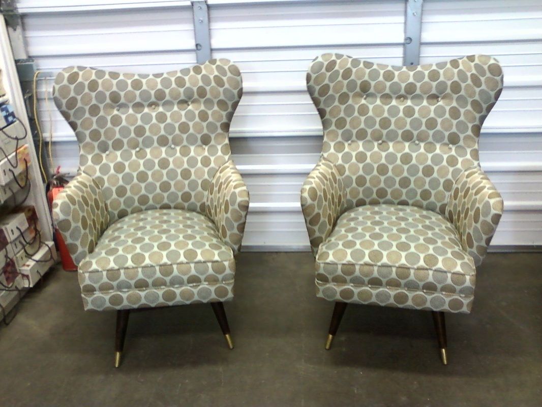 Two chairs with polka dots on them are sitting next to each other in a garage.