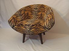 A chair with a zebra print on it is sitting on a white surface.