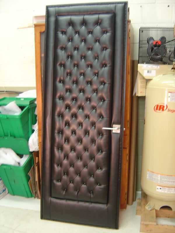 A tufted door is sitting next to an irwin tank