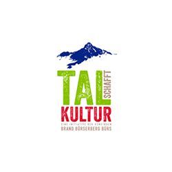 Ein Logo für ein Unternehmen namens Tal Kultur mit einem Berg im Hintergrund.