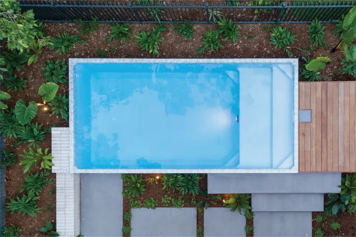 An aerial view of a swimming pool in a backyard