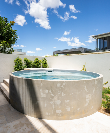 A round swimming pool installed above ground with a blue sky in the background