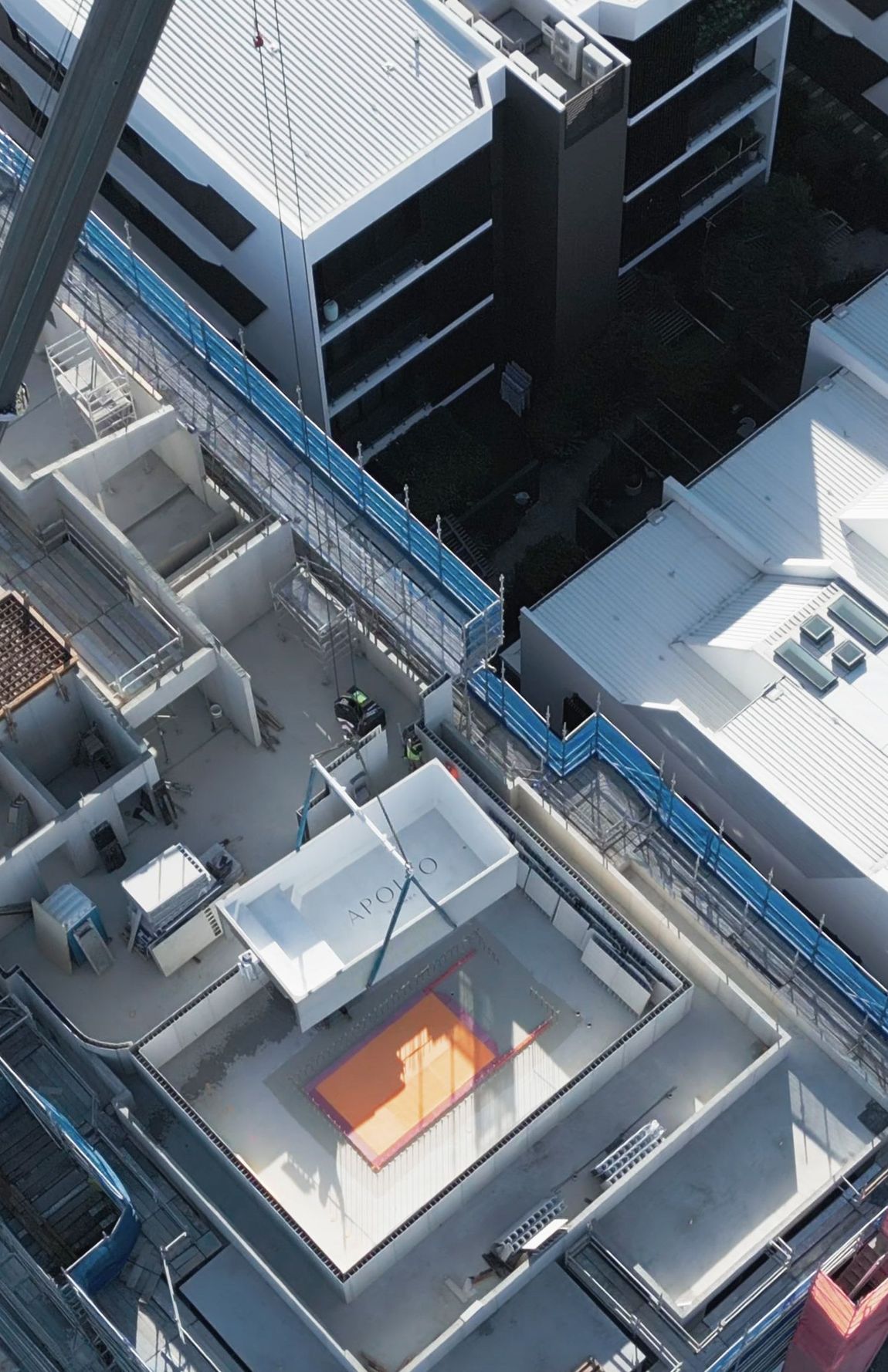 An aerial view of a construction site with a large plunge pool in the middle