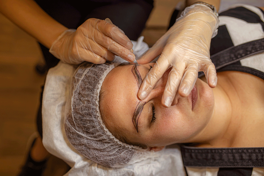 Woman Worn A Plastic Gloves  During Microblading The Eyebrow — Evansville, IL — Permanent Makeup & More