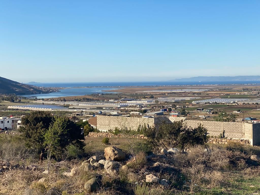 A view overlooking a land with Pacific ocean view under a clear blue sky.
