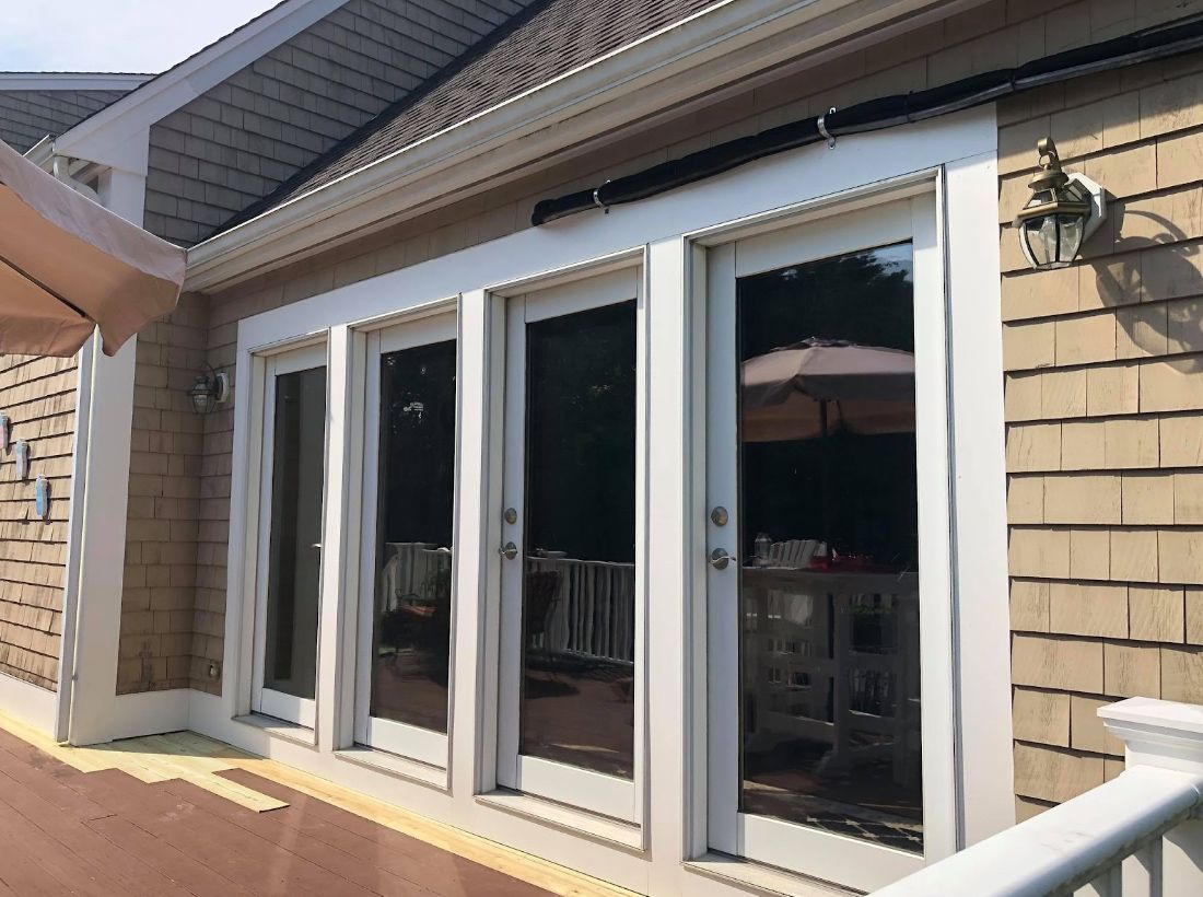 A house with a lot of windows and sliding glass doors.