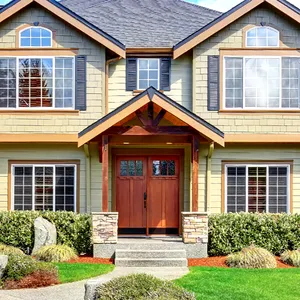 A large house with a lot of windows and a wooden door.
