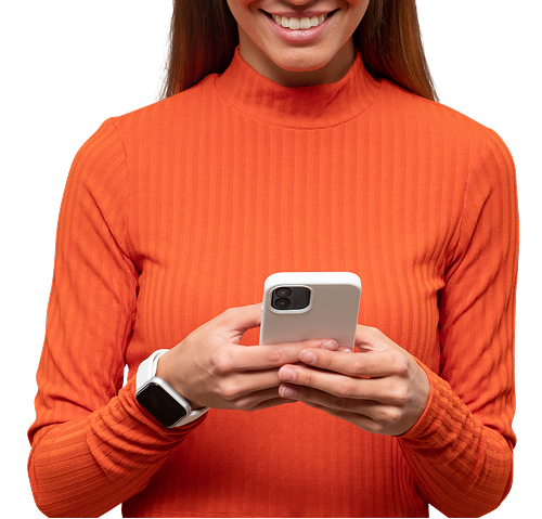 Woman smiling, wearing orange turtleneck, using a white phone with a white smartwatch.