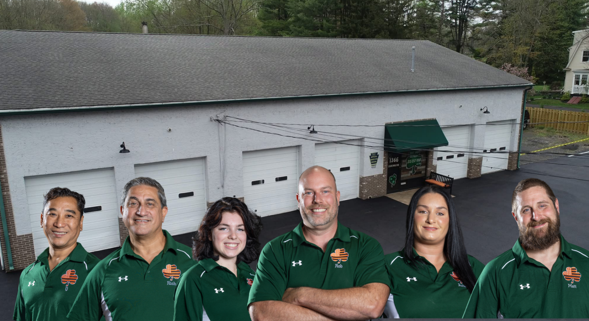 Group of people in green shirts outside Robert A. Karron's garage, with a dog.