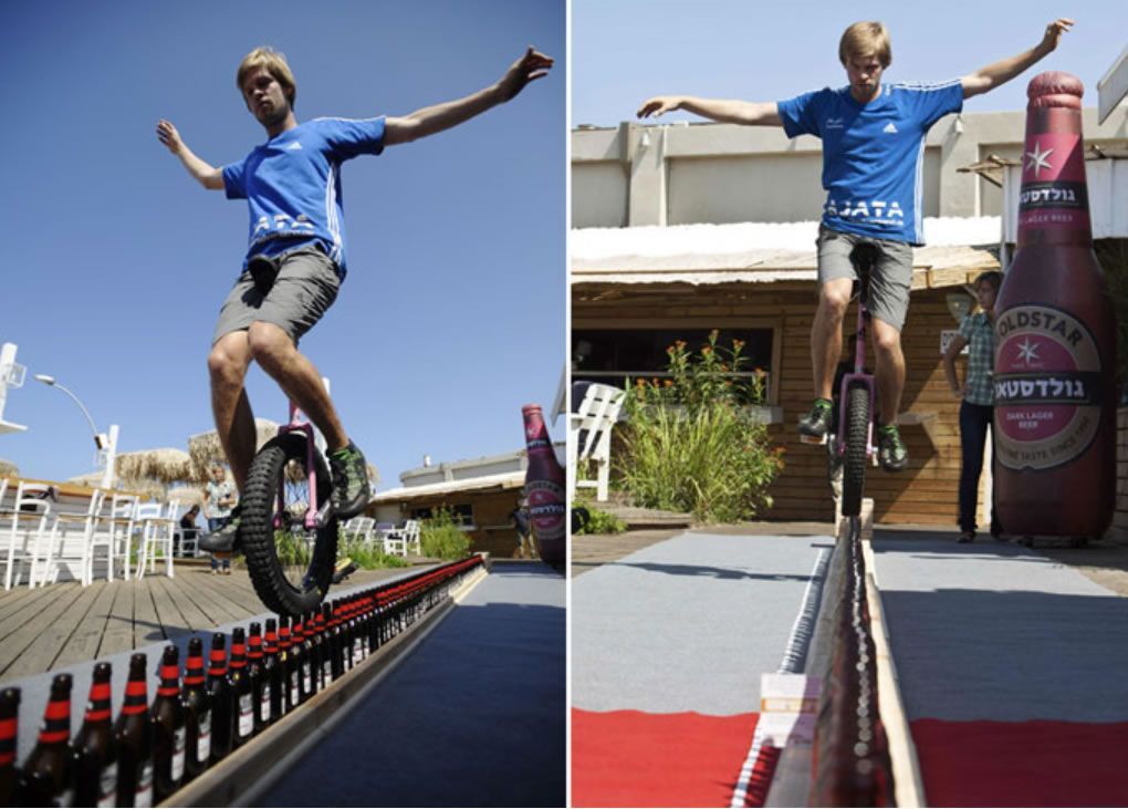 Riding unicycle on beer bottles: Lutz Eichholz sets world record (Video)