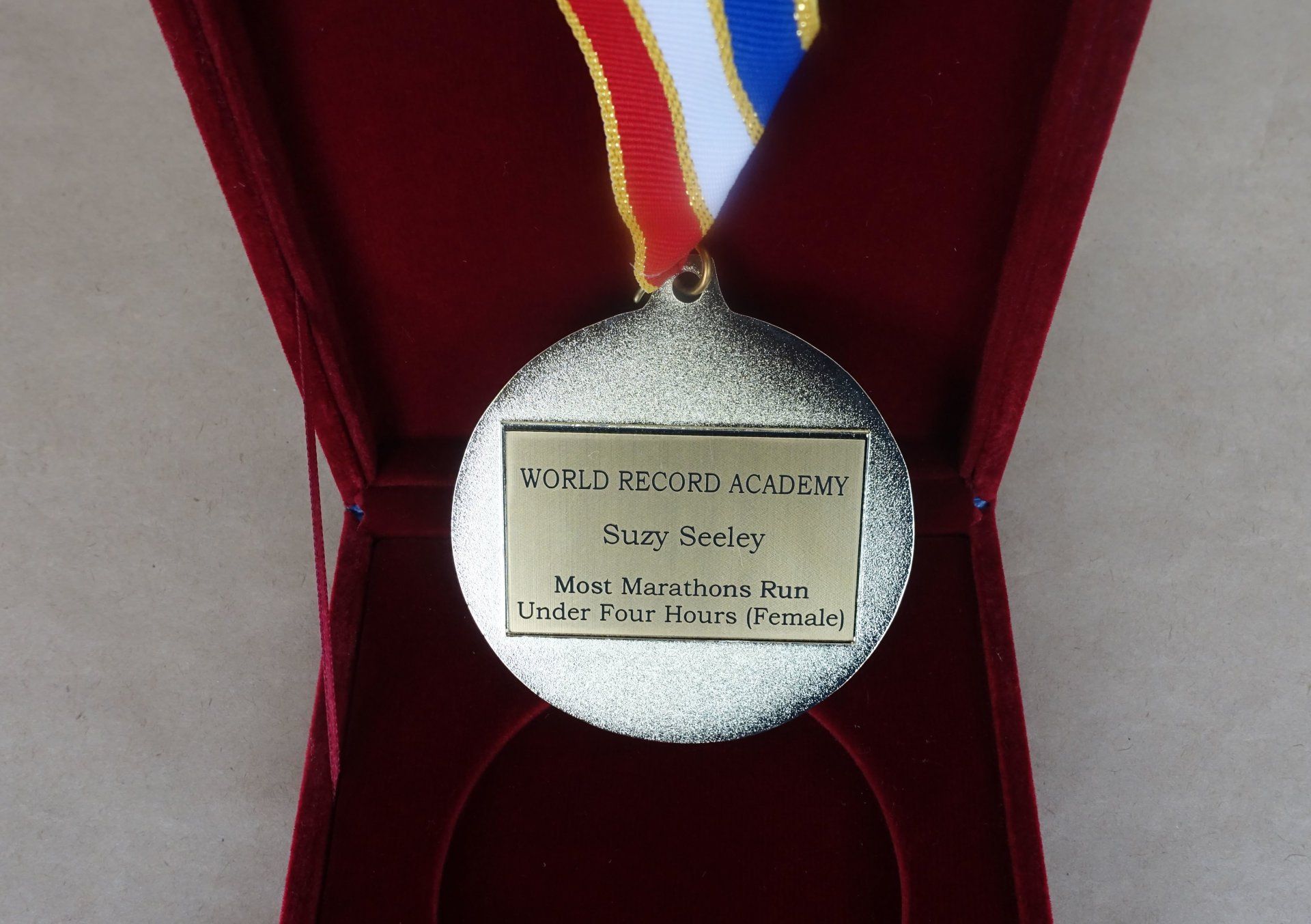   World Record Holder Medal for Mrs. Suzy Seeley, the new record holder for the Most Marathons Run Under Four Hours  (Female). Photo: AOWR