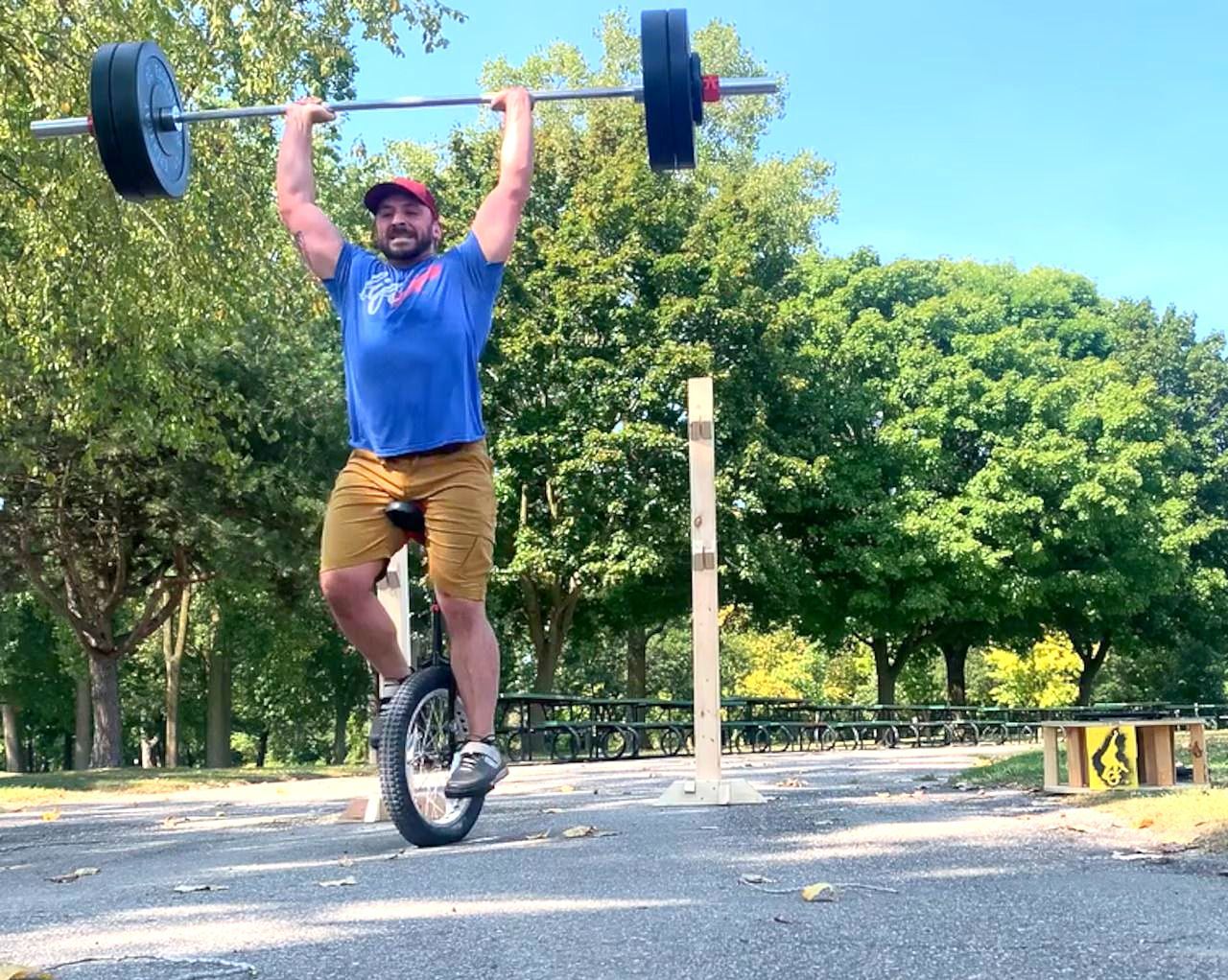 Heaviest single weight lifted by barbell overhead press while riding a unicycle, Dan Galanto 