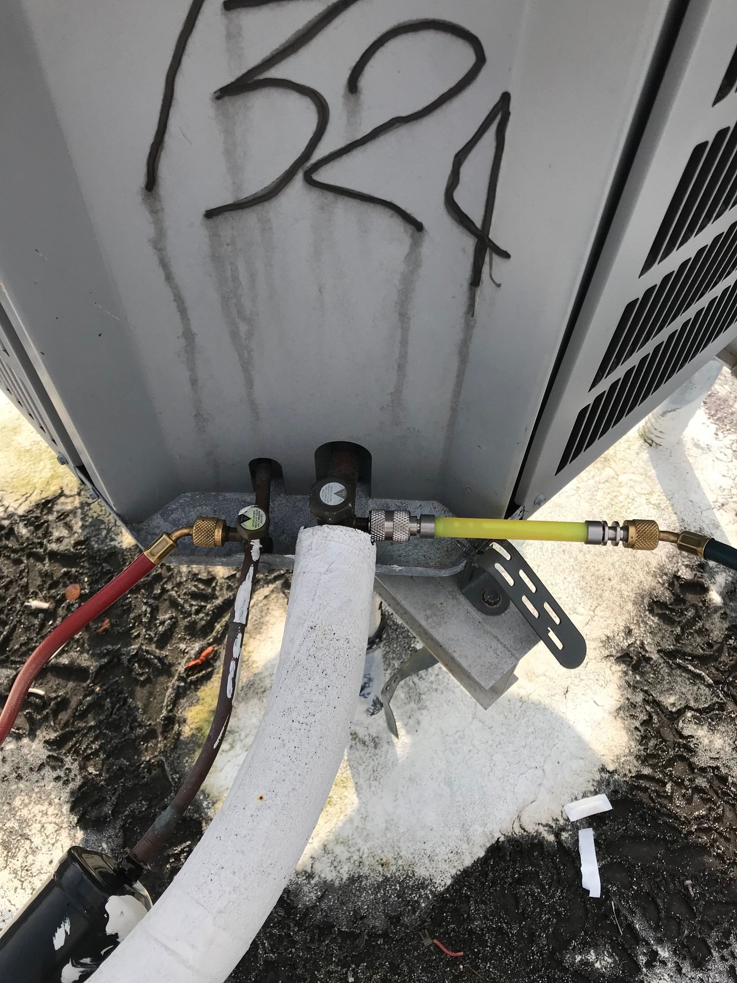 A close up of a hose attached to a building with the number 524 written on it.