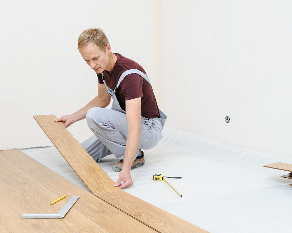 A person measuring a wood floor l Hardwood Flooring Installation Oklahoma City Ok, Temple Johnson Fl