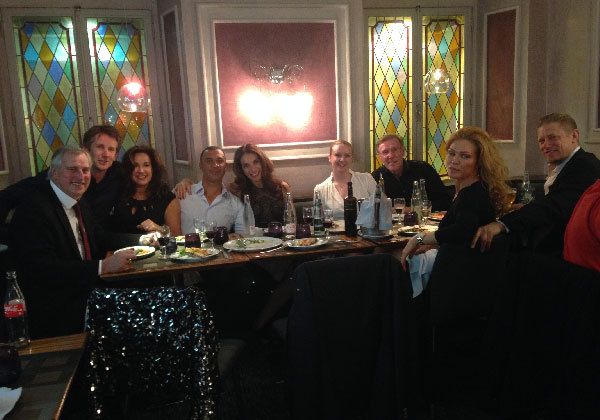 corrinne and ruud with their friends at a dining table