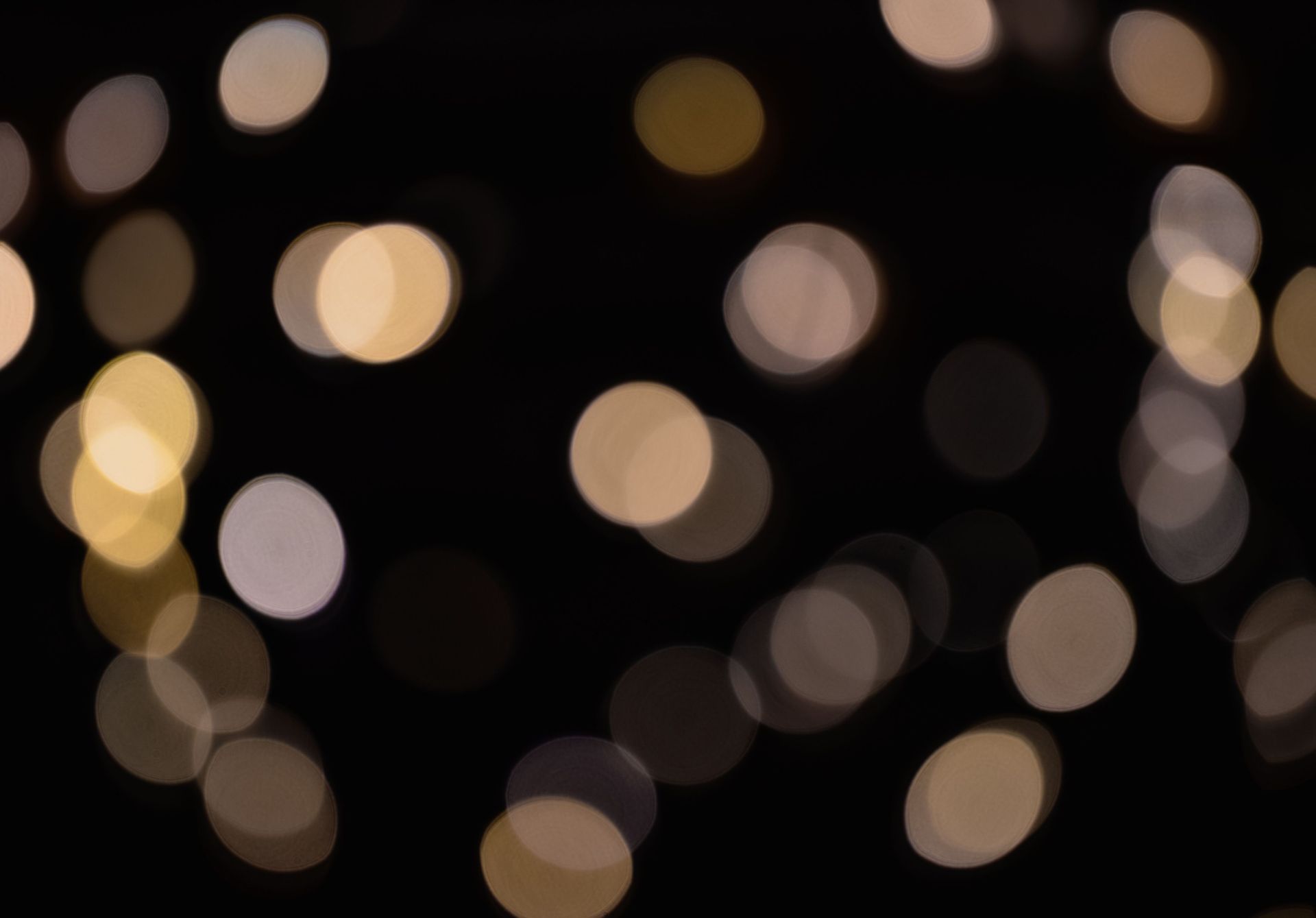 Lumières chaudes et floues (bokeh) sur fond sombre