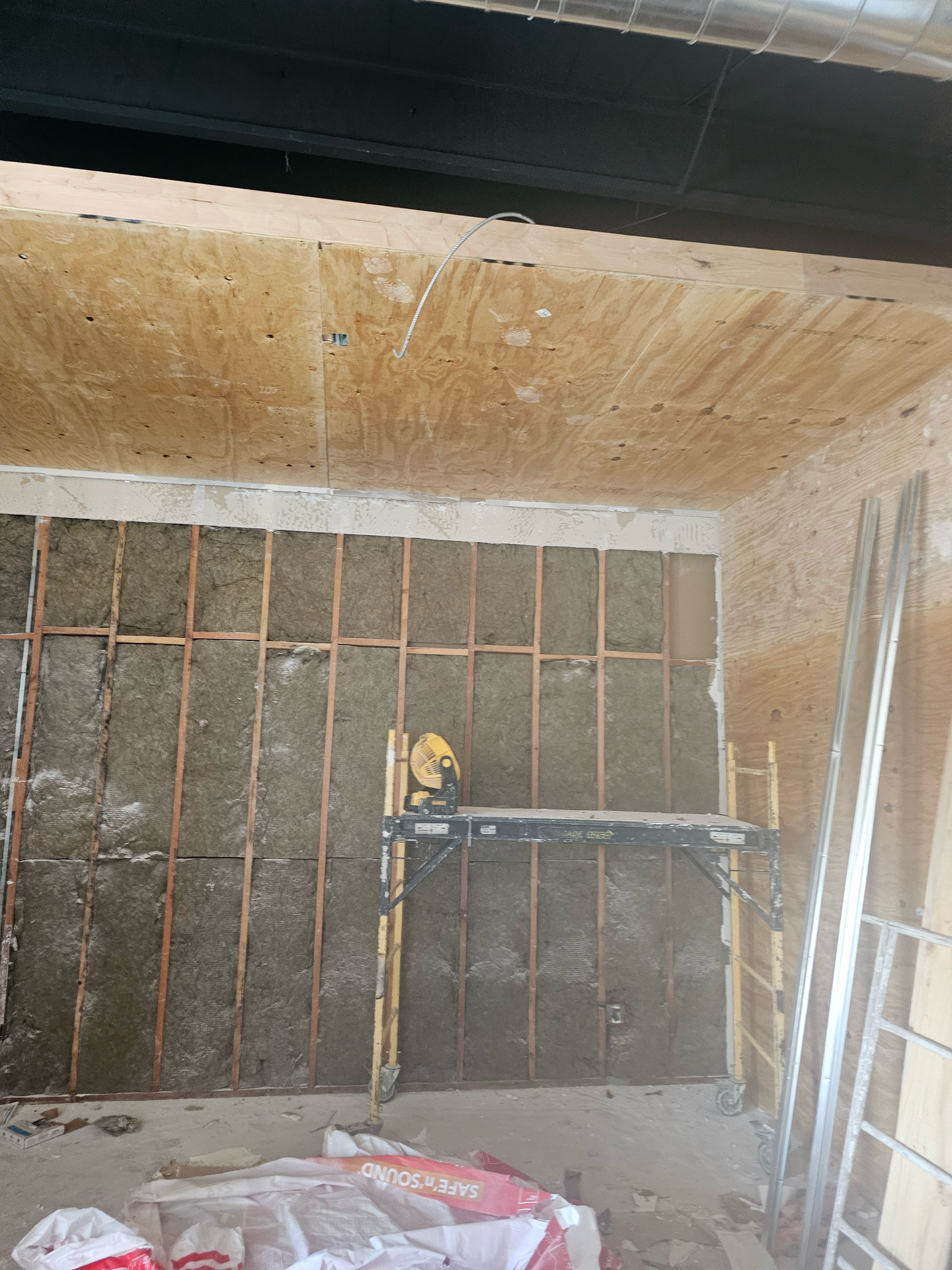 A room with a scaffolding and a ladder in it