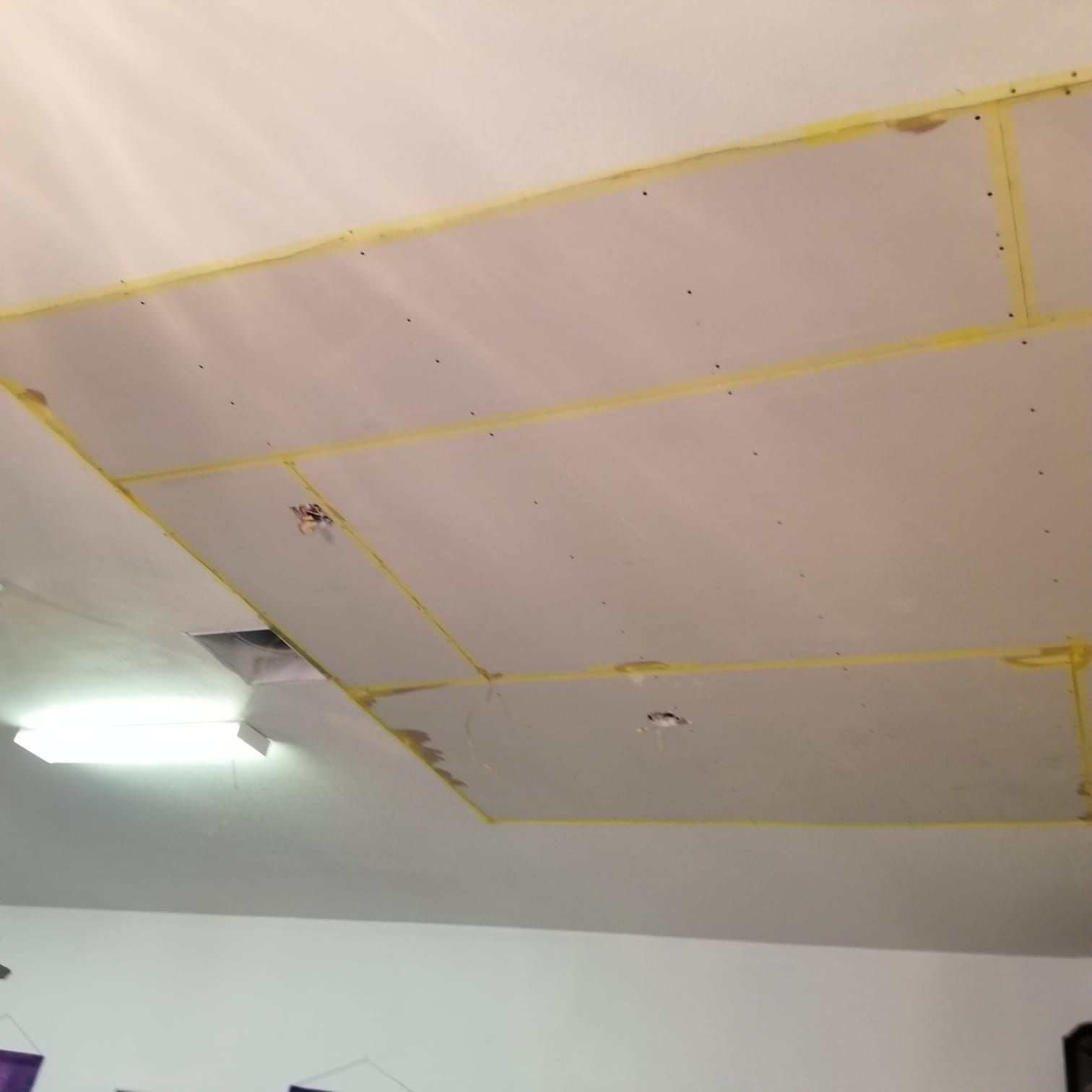 A ceiling with a lot of holes in it