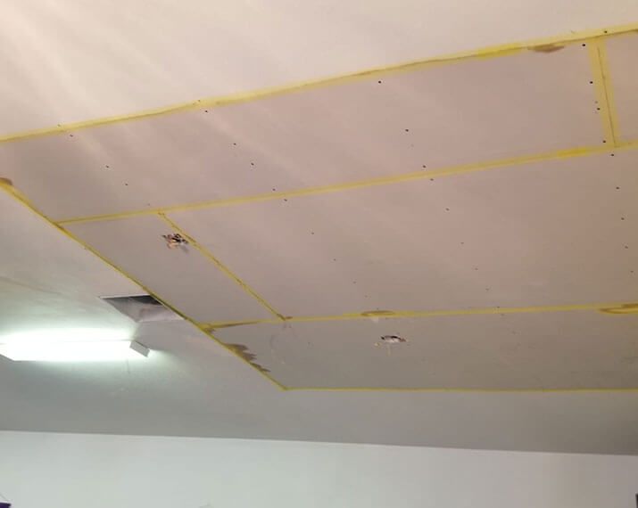 A ceiling with a lot of holes in it
