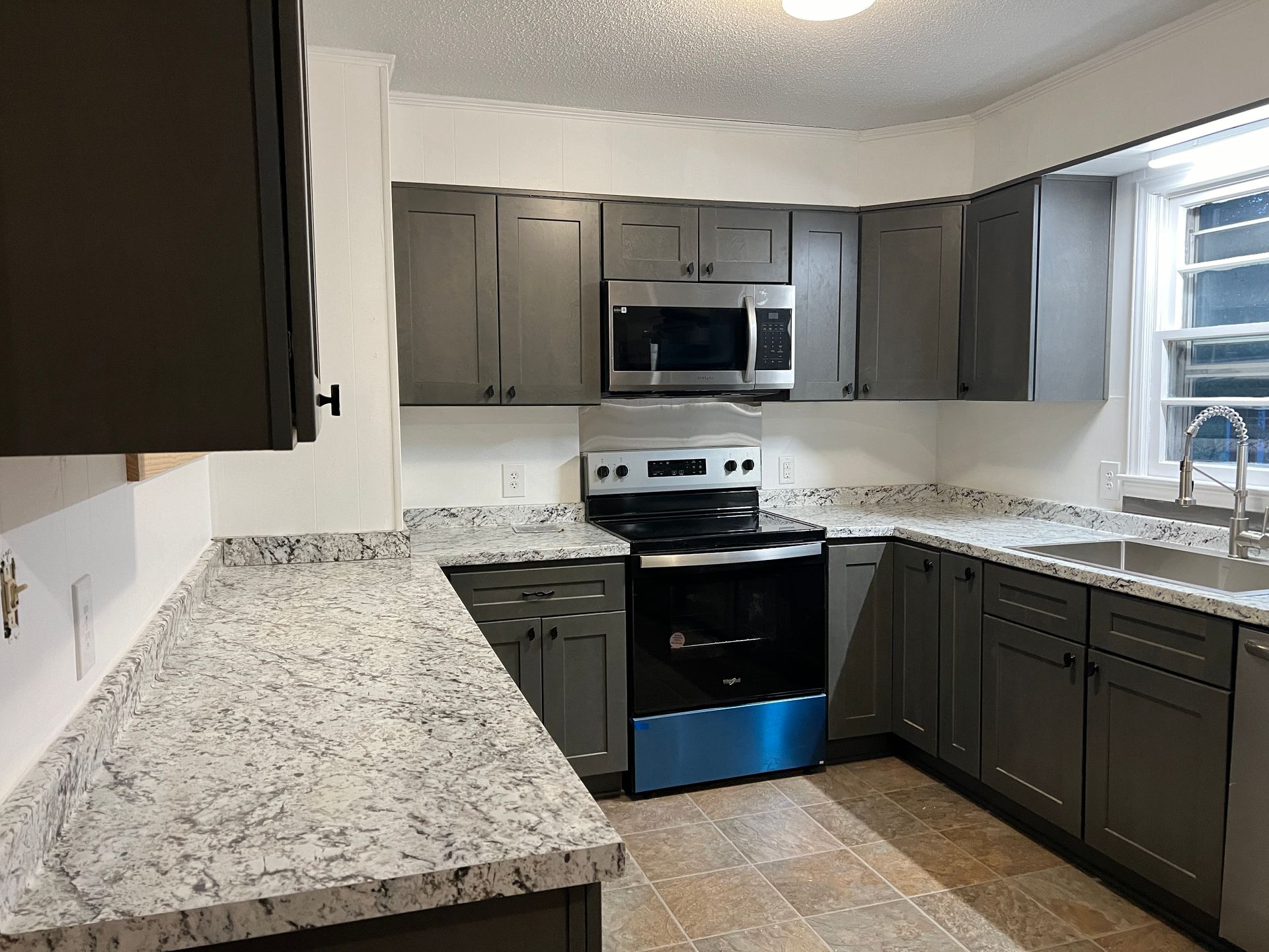 A kitchen with stainless steel appliances and granite counter tops