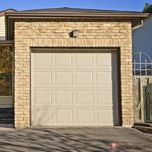 A white garage door is in front of a brick house best material for garage doors Smart Garage Door Service