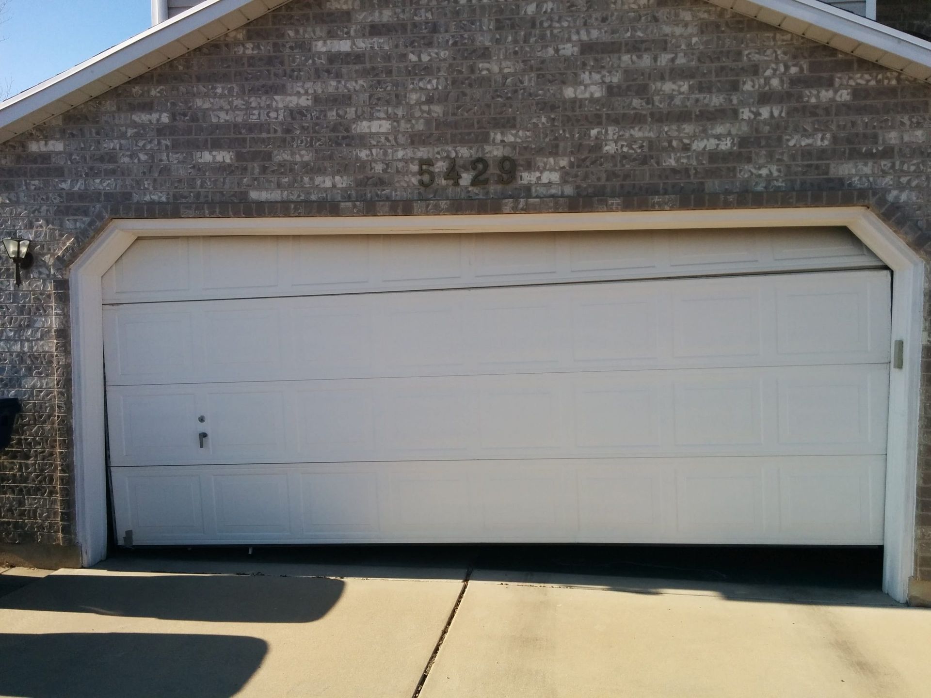 Why is my garage door uneven or sagging on one side?