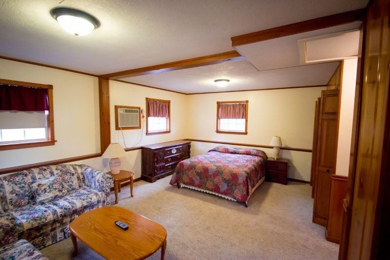 A bedroom with a bed , couch and coffee table