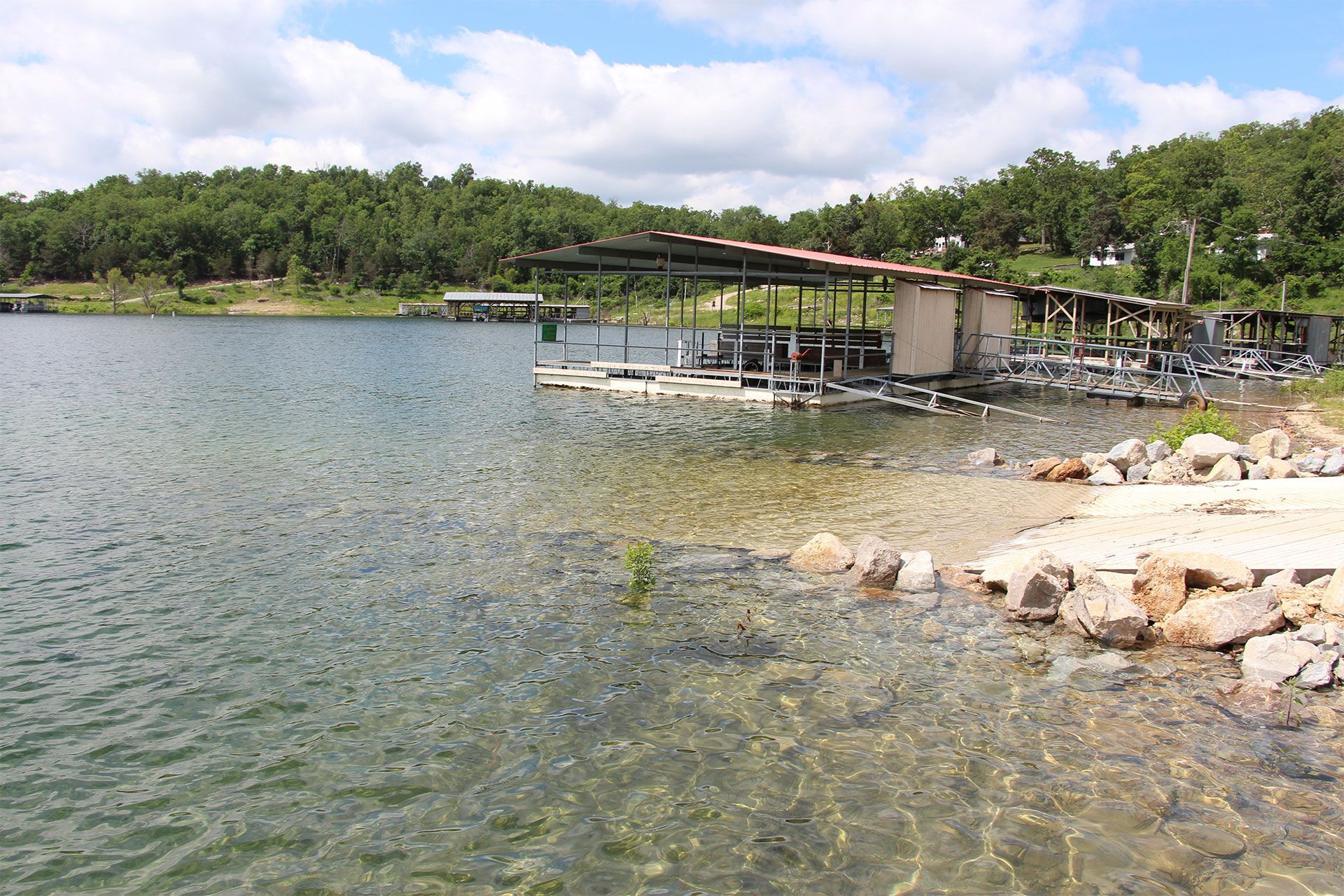 A lake with a dock in the middle of it
