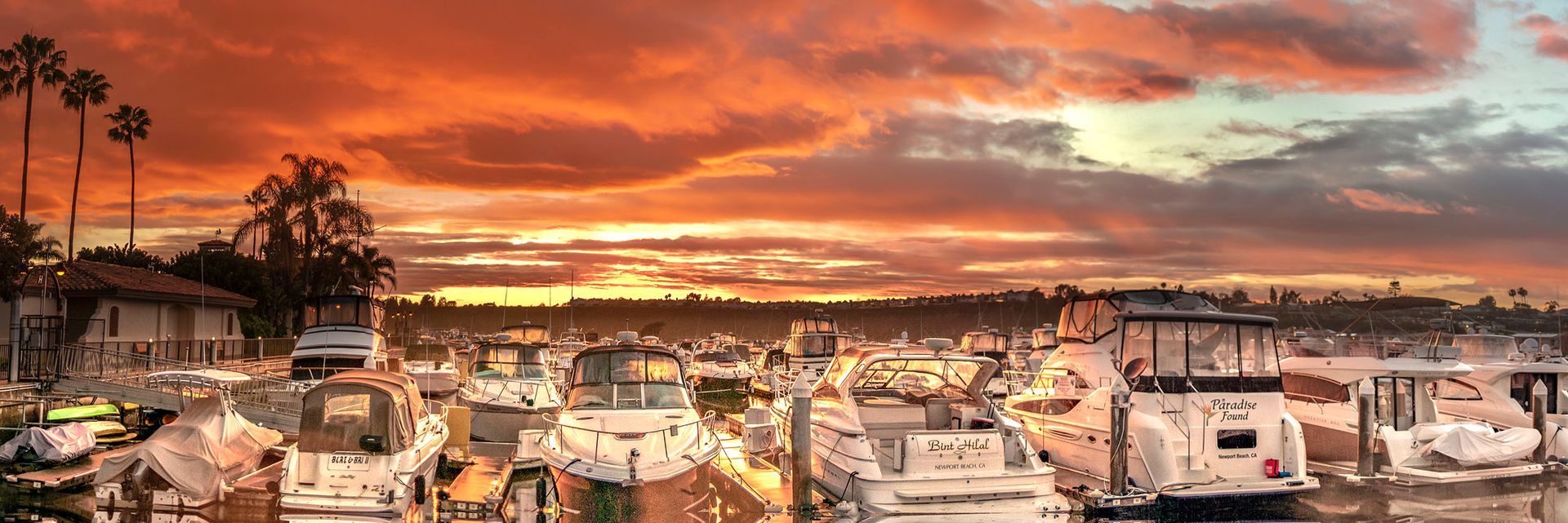 Newport Dunes Marina dock with a golden sunset in the background.