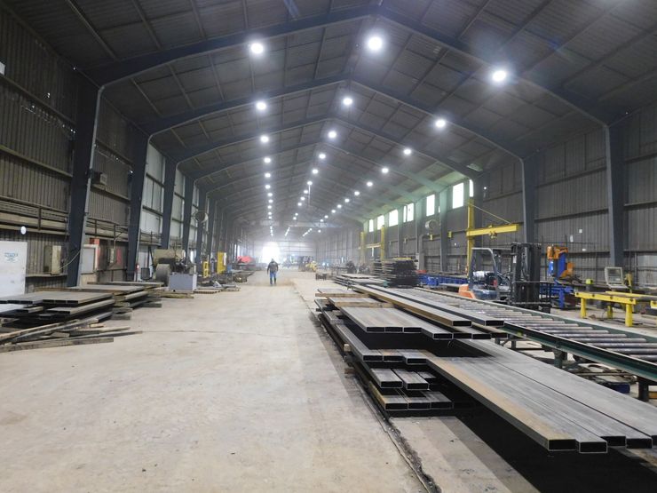 A large warehouse filled with lots of boxes and lights.