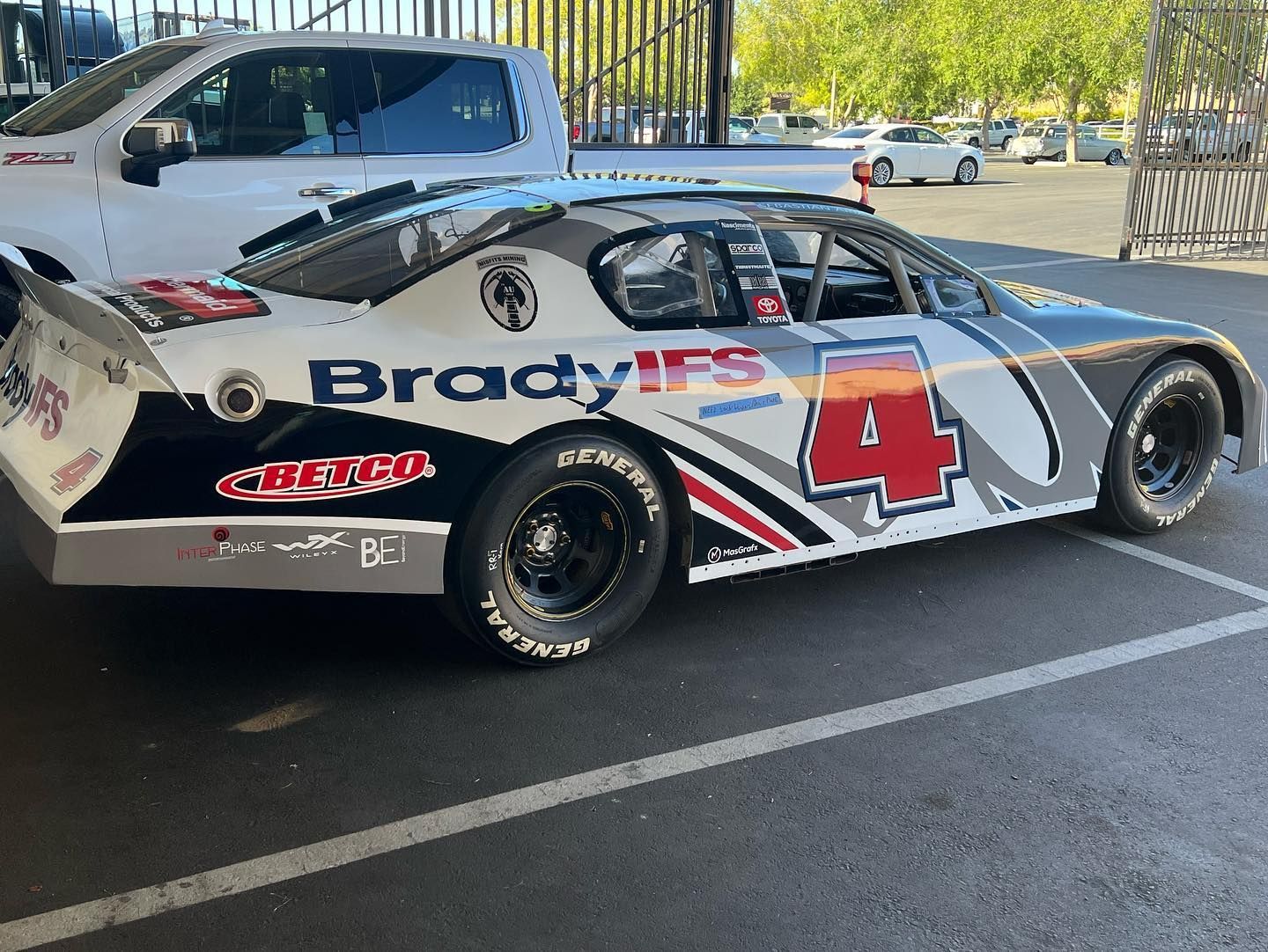 a race car with the number 4 on it is parked in a parking lot