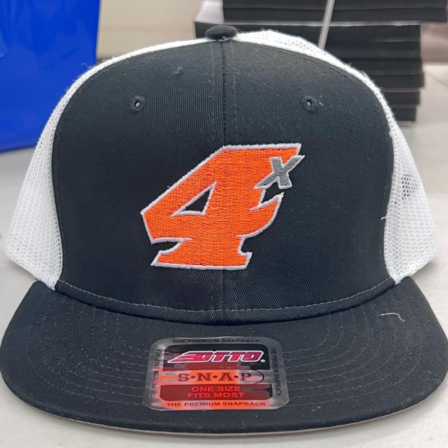 a black and white hat with the number 4 on it