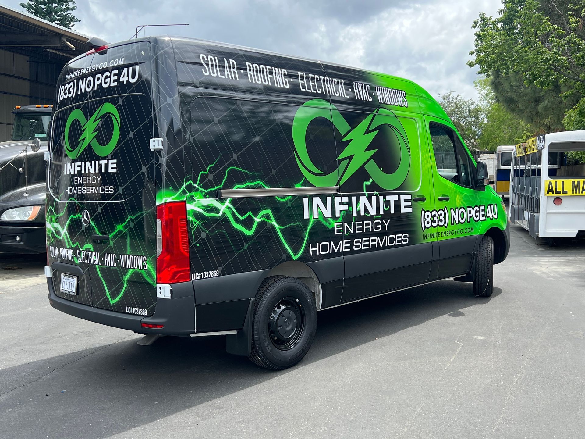 a black and green van is parked on the side of the road .