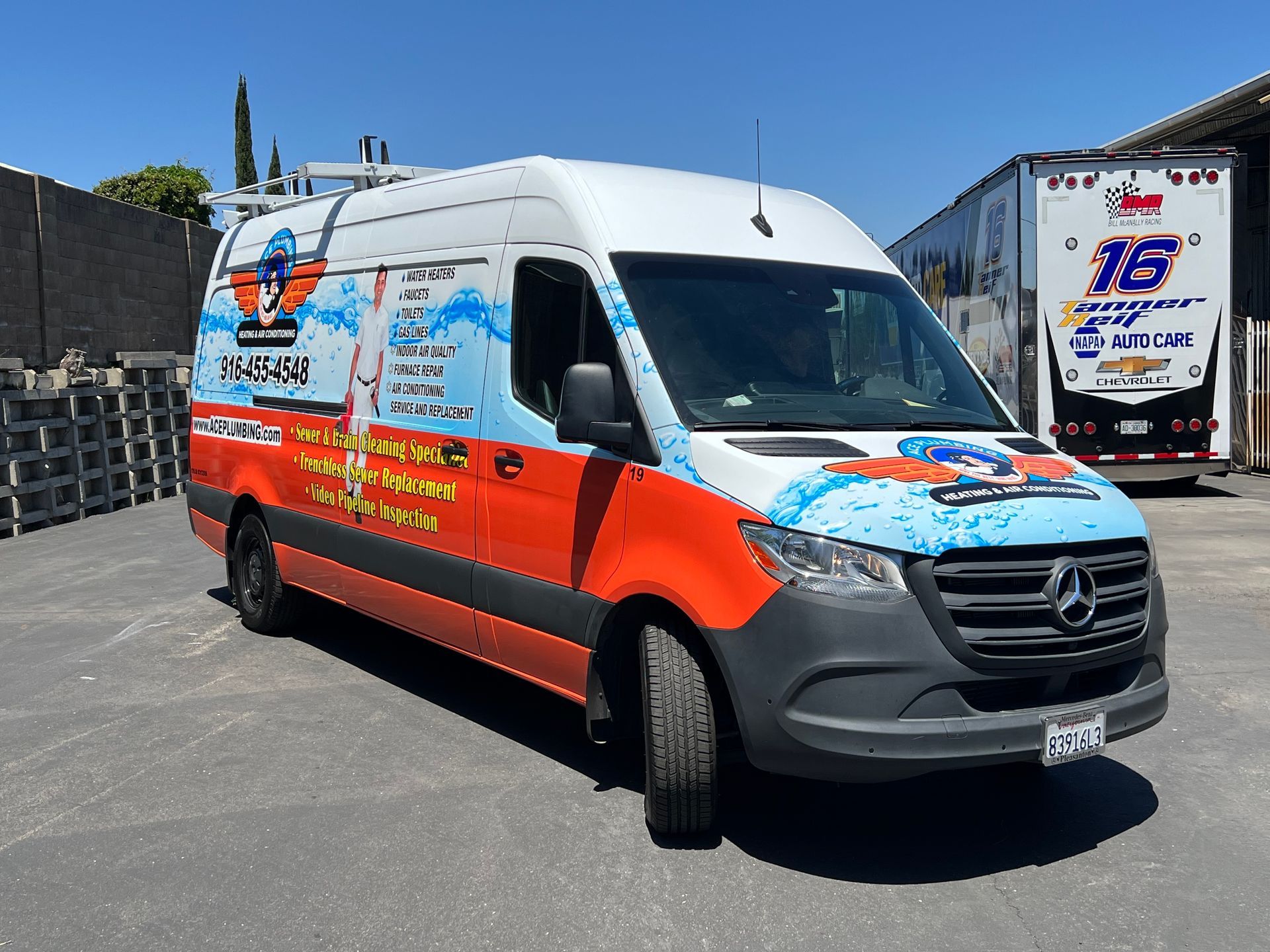 a red and white van with the number 16 on the back is parked in a parking lot .
