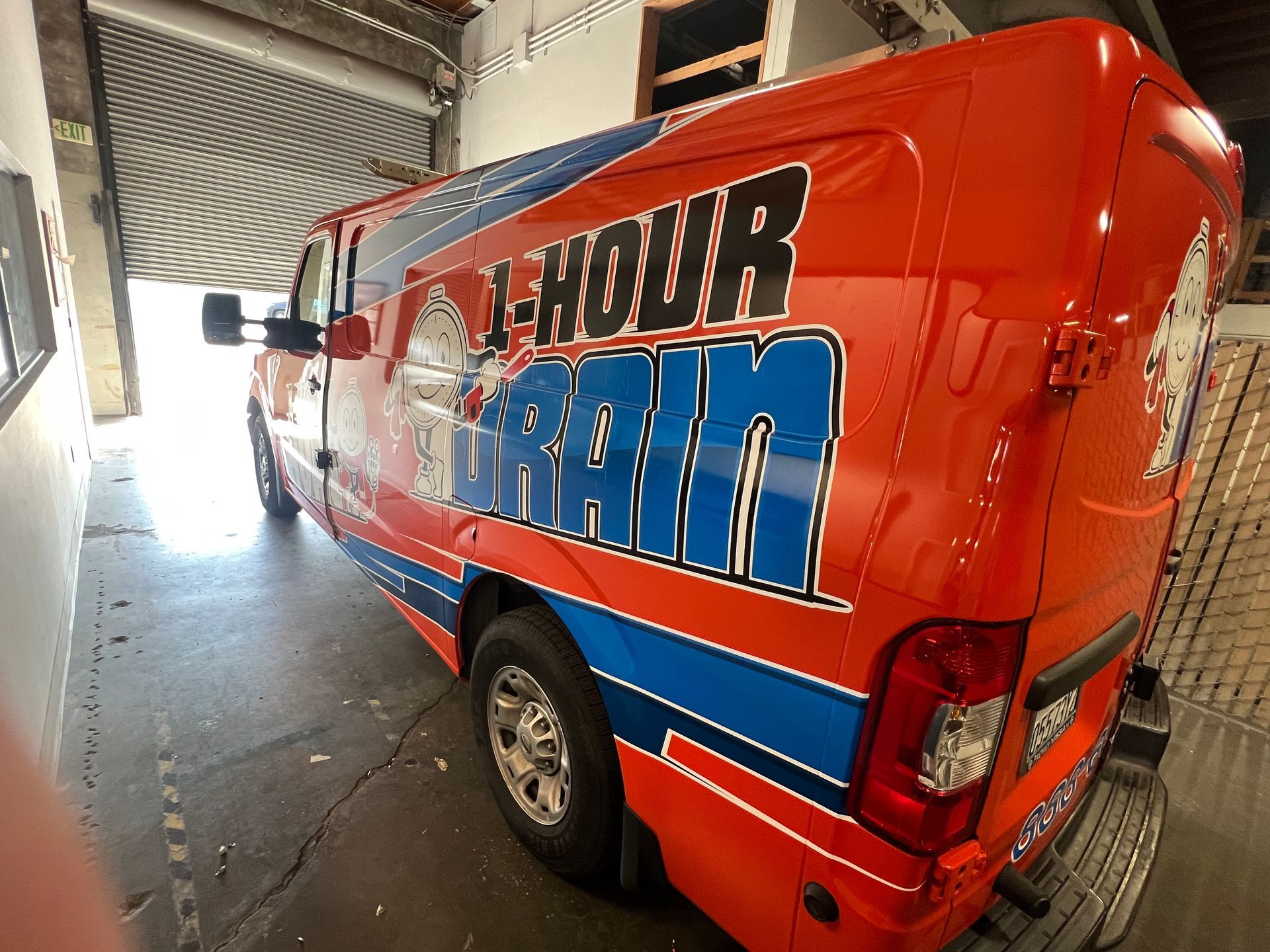 a red and blue van that says 1 hour drain on it