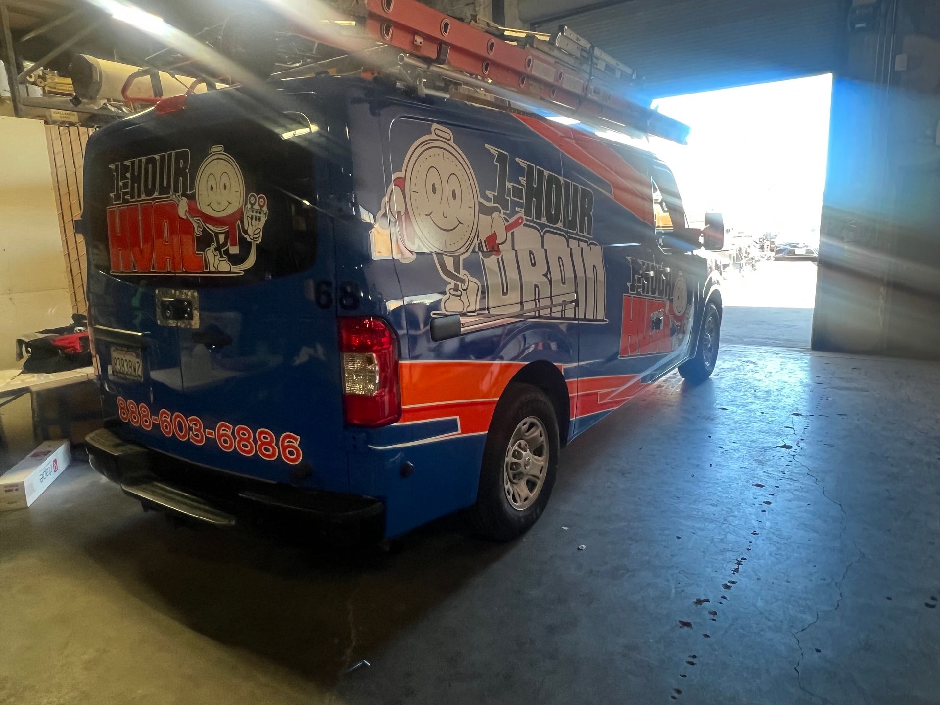 a blue and orange van is parked in a garage