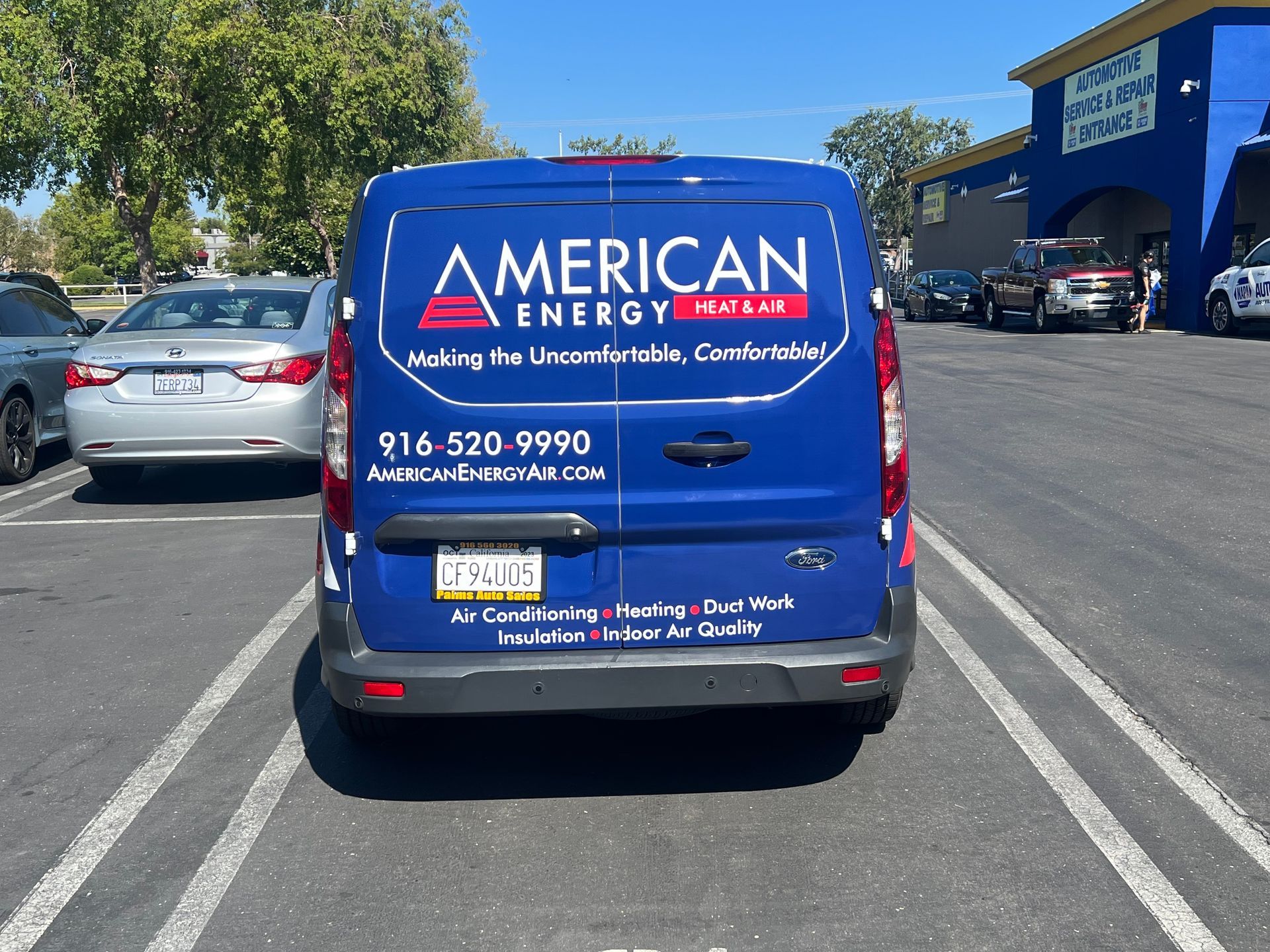 a blue american energy van is parked in a parking lot
